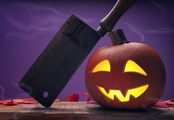 Carved halloween pumpkin Jack o lantern on a rustic wooden table