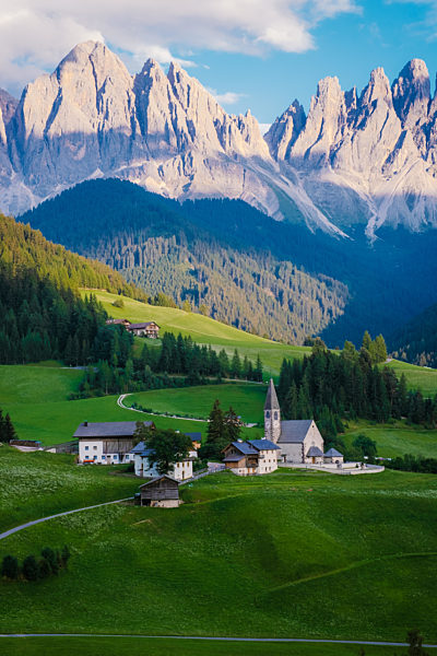 Santa Magdalena village in Val di Funes on the italian Dolomites. Autumnal view of the valley with colorful trees and Odle mountain group on the background. Italy