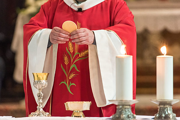 Priest giving Eucharist