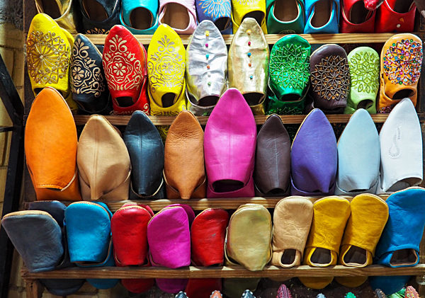Handmade colourful leather slippers on display at traditional souk - street market in Morocco