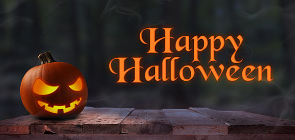 Carved halloween pumpkin Jack o lantern on a rustic wooden plank