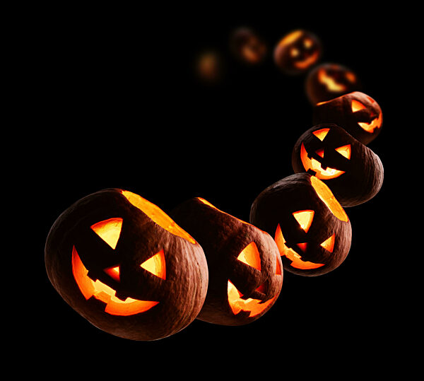Glowing pumpkins levitate on a black background