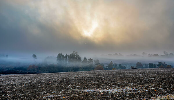 Autumn foggy and misty sunrise landscape