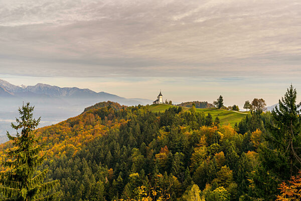 A view of the Church of Saint Primoz and the Julian Alps in late autumn