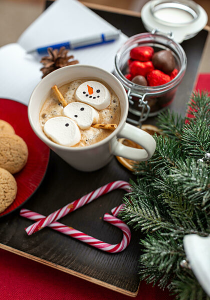 marshmallow snowman in cup of coffee on christmas