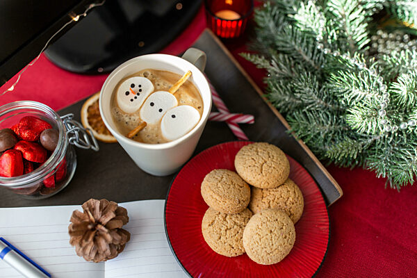 marshmallow snowman in cup of coffee on christmas