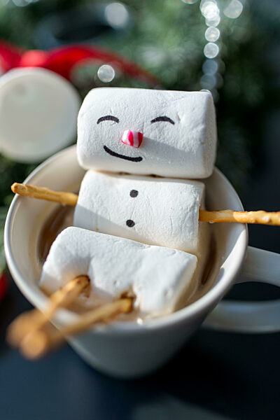 marshmallow snowman in cup of coffee on christmas