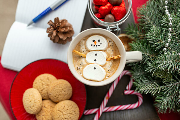 marshmallow snowman in cup of coffee on christmas