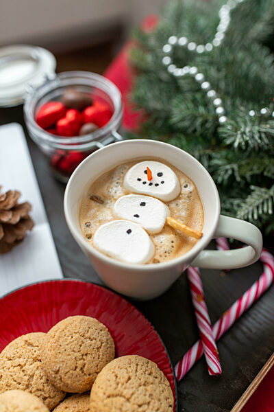 marshmallow snowman in cup of coffee on christmas