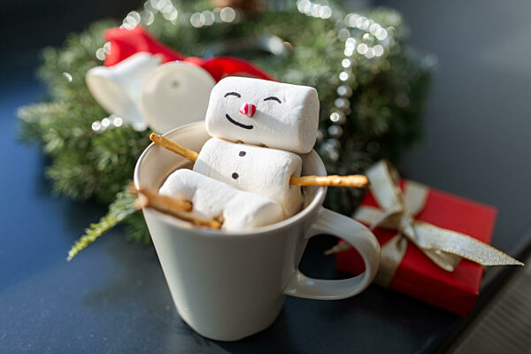 marshmallow snowman in cup of coffee on christmas