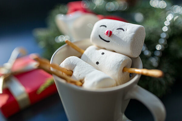 marshmallow snowman in cup of coffee on christmas