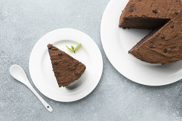 top view chocolate cake slice with spoon mint. High quality and resolution beautiful photo concept