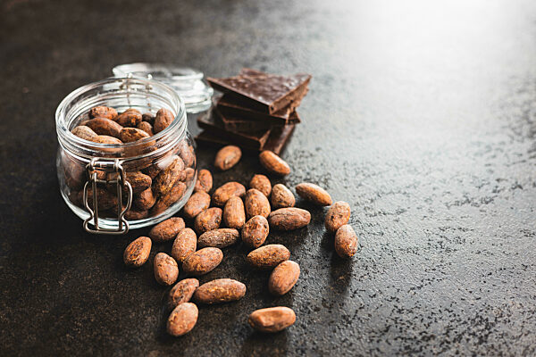 Dried cocoa beans. Cacao beans in jar.