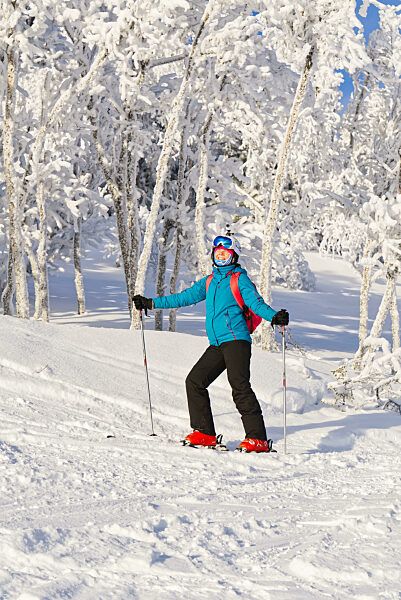 Ski, skier, sun and winter fun woman enjoying ski vacation Winter, leisure, sport and people concept