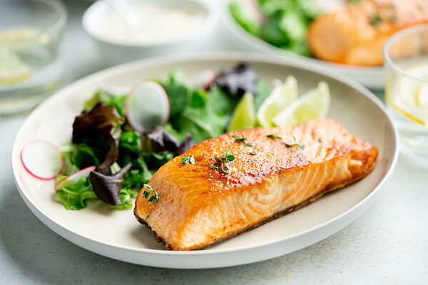 Grilled salmon fillet and fresh vegetable salad. Mediterranean diet.