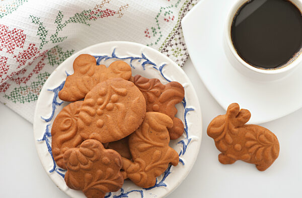 Top view of easter gingerbread cookies and cup of coffee