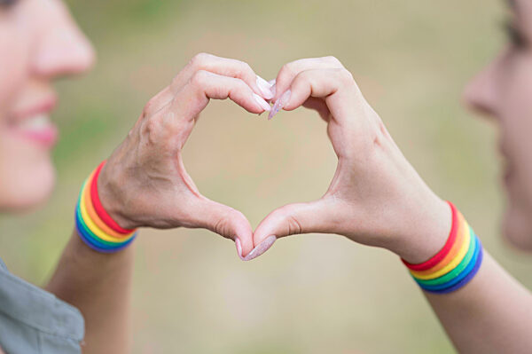lesbian couple with lgbt bracelete. High quality photo