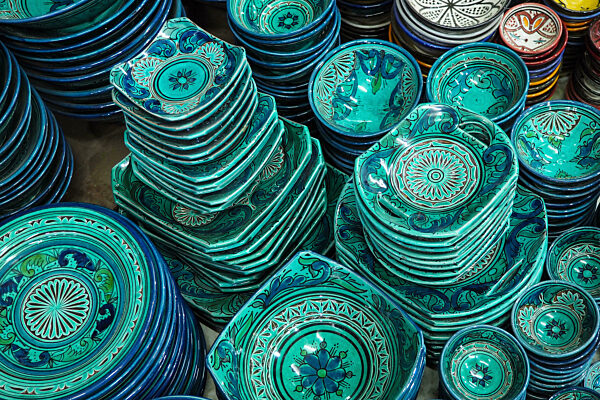 Pile of green and blue plates or cups displayed at market in Morocco
