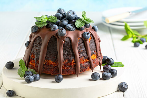 Marble bundt cake with chocolate icing and blueberries.