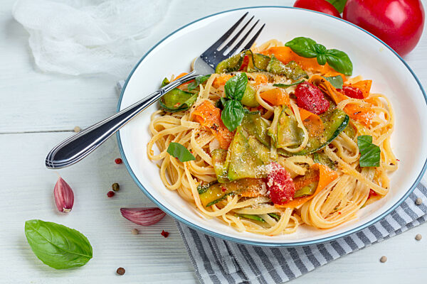 Pasta with vegetables in tomato sauce with parmesan.
