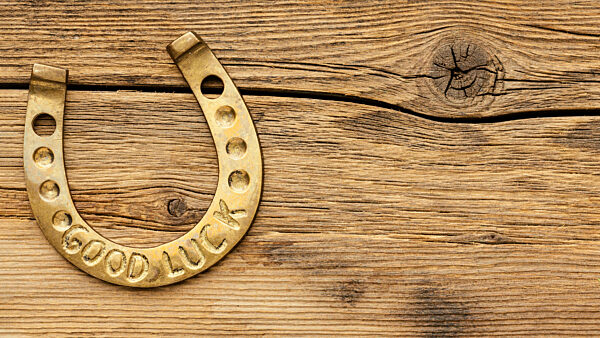 golden horseshoe wooden background