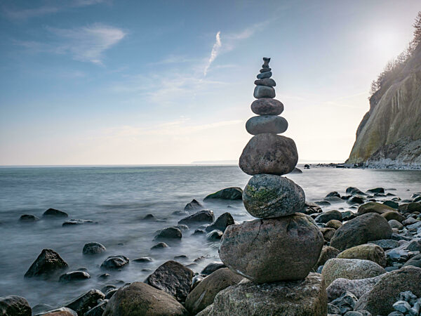 Stacked pebbles in stony pillar bellow white cliff of Cape Arkona.