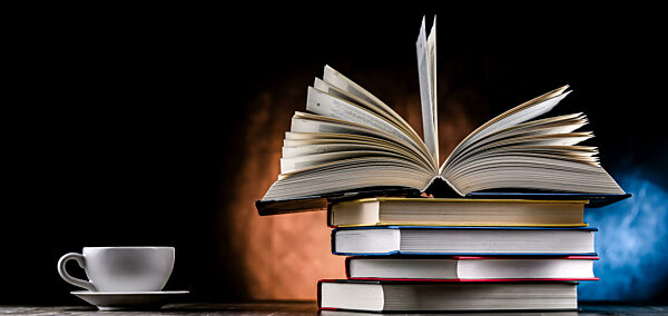 A composition with books and a cup of coffee.