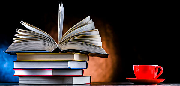 A composition with books and a cup of coffee.