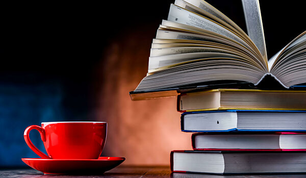 A composition with books and a cup of coffee.