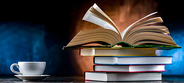 A composition with books and a cup of coffee.