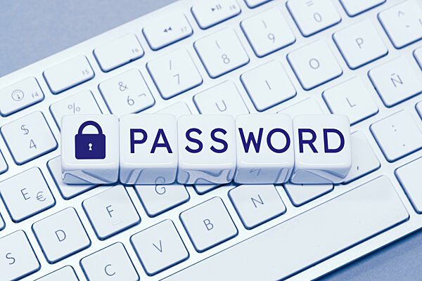 Password word and Closed padlock icon on cube blocks on computer keyboard