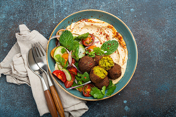 Middle Eastern Arab meal with fried falafel, hummus, vegetables salad