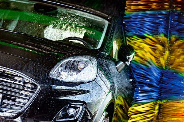 A motorcar in an automatic car wash.