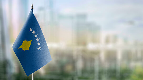 A small Kosovo flag on an abstract blurry background