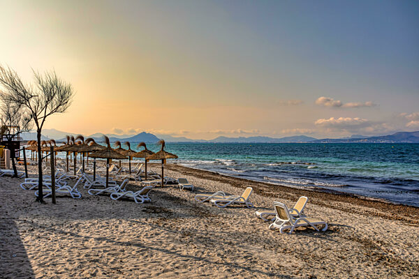 Can Picafort Beach with straw umbrellas and sun loungers, Can Picafort, Balearic Islands Mallorca Spain.