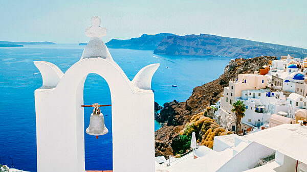 Oia Santorini with blue domes and white washed house during sunset at the Island of Santorini Greece