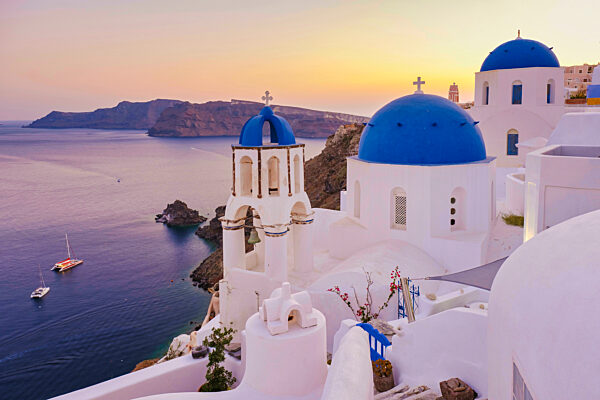sunrise by the ocean of Oia Santorini Greece, traditional Greek village