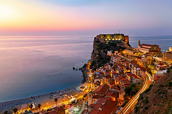 The city of Scilla Calabria Italy. Elevated view of the illuminated Ruffo castle at sunset