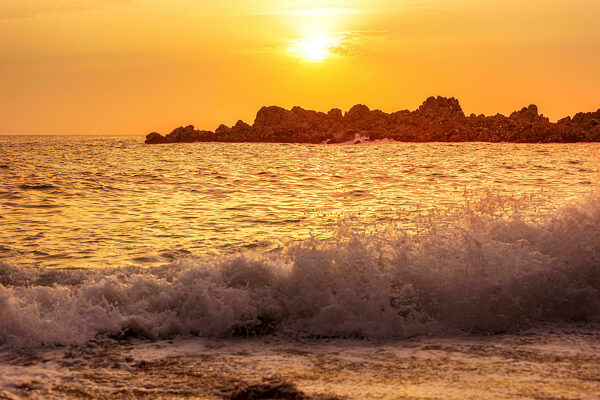 Sunset evening landscape, sea waves, rocky island
