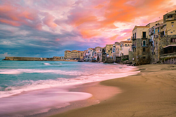 sunset at the beach of Cefalu Sicily, old town of Cefalu Sicilia panoramic view at the colorful village