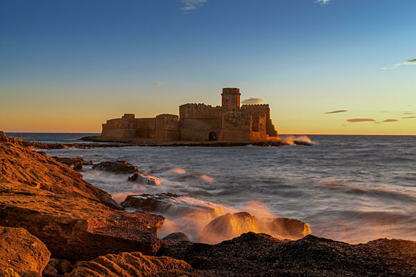 view of the Le Castella fortress in Isola di Capo Rizzuto at sunset
