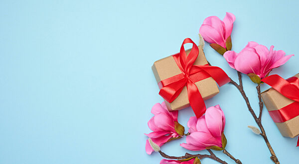 Box tied with a red ribbon on a blue background