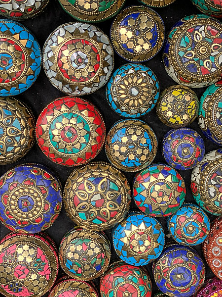Small, round, intricately patterned metal boxes on sale, Fez, Morocco