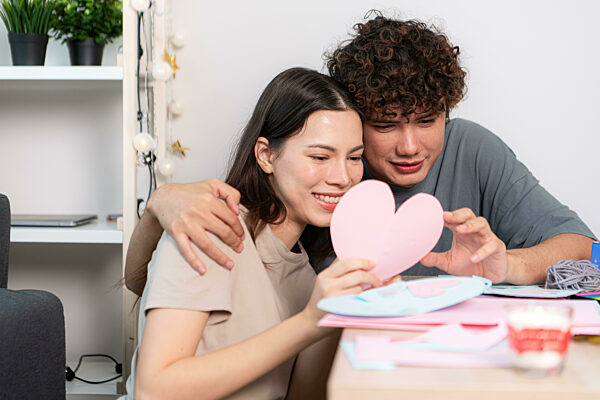 Ein junges Paar mit Aktivitäten zum Valentinstag zu Hause