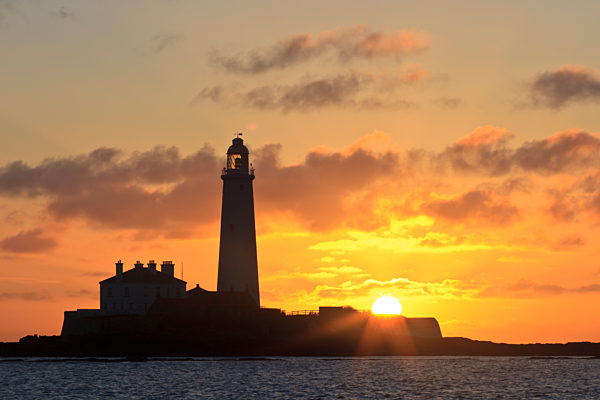 Silhouette of St Mary's Lighthouse (no longer functioning as a lighthouse) near Whitley Bay at sunrise.