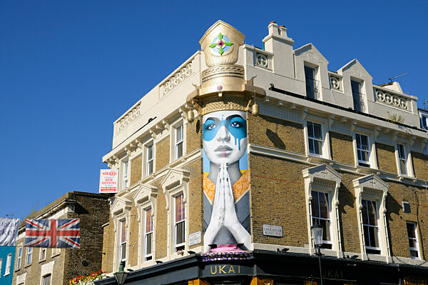 Mural street art entitled Lady Kinoko by artist Fin DAC on the corner of Portobello Road and Lancaster Road in Notting Hill in London.