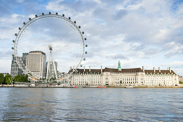 The massive London Eye ferris wheel on the edge of the River Thames in London.