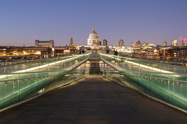 The Millennium Bridge and St Paul's Cathedral at dusk.