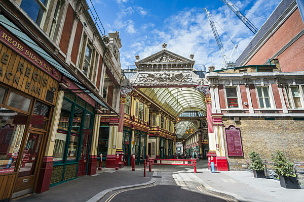 One of the entrances to the Leadenhall Market in Greater London pictured under a bright sky.