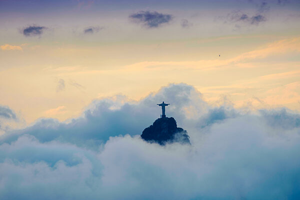 Brazil, Rio de Janeiro, the Christ Statue (Cristo Redentor) on the summit of Corcovado mountain in a sea of clouds, copy space